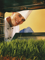 Chef looking at lawn in oven - RDF00118