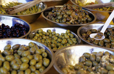 Various olives in bowls, elevated view, close-up - THF00216