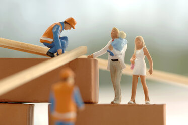 Figurines of construction workers and family at construction site - ASF02192