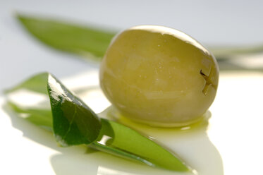 Olive and leaf in plate, close-up - ASF02228