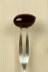 Olive with fork, close-up - ASF02215