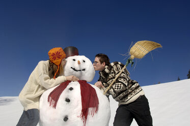 Junges Paar küsst Schneemann, tiefer Blickwinkel - WESTF00906