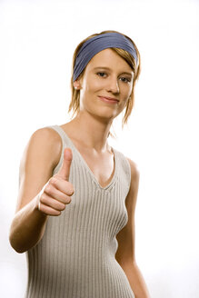 Young woman showing thumbs up sign, portrait - CLF00116