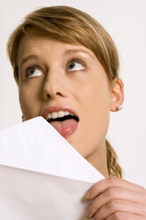 Young woman licking envelope - CLF00107