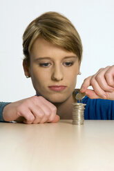 Young woman with pile of coins - CLF00098