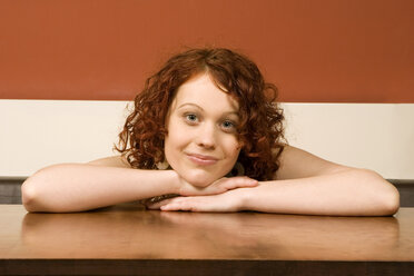 Young woman leaning on table - CLF00200