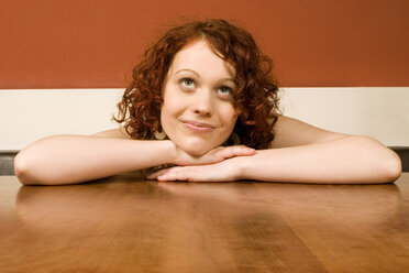 Young woman leaning on table - CLF00199