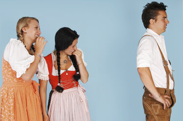 Two young women looking at man and smiling, close-up - 00027LR-U