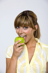 Junge Frau isst Apfel, Porträt, Nahaufnahme - WESTF01258