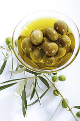 Fresh green olives and olive oil in glass bowl - 04389CS-U