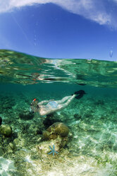 Philippines, Dalmakya Island, woman snorkelling in sea, underwater view - GNF00785