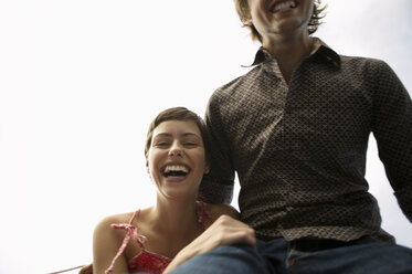 Young couple laughing, low angle view - WEST01556