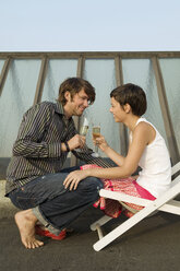 Young couple with champagne, smiling, side view - WEST01538