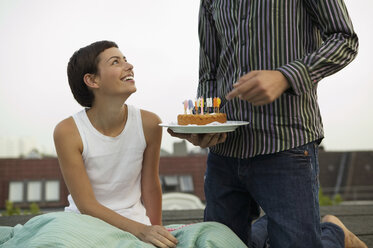 Man giving birthday cake to woman - WEST01524