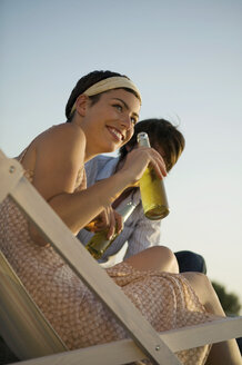 Young couple enjoying drink, low angle view - WEST01498