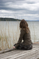 Woman sitting on jetty - CLF00215