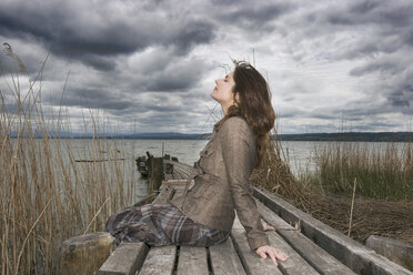 Woman sitting on jetty - CLF00214