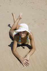 Young woman lying on beach, looking away, elevated view - WESTF01851