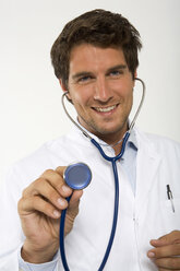 Male doctor holding stethoscope, close-up, portrait - WESTF01616