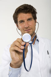 Male doctor holding stethoscope, close-up, portrait - WESTF01615