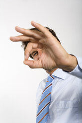 Young businessman gesturing ok sign (focus on background) - WESTF01560