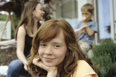 Little girl, portrait, brother and sister in background - NHF00180