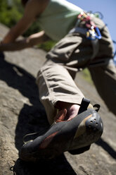 Young man mountain climbing in climbing wall - WESTF02348