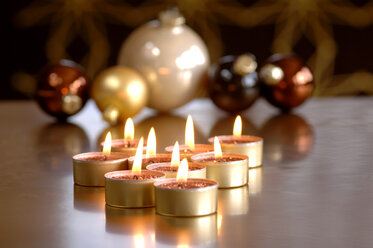 Christmas baubles and burning tea lights - ASF02493