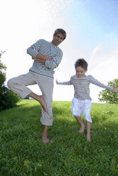 Father and son (4-7) in park, boy jumping - WESTF02306