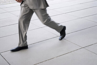 Businessman running, low section, (blurred motion) - WESTF02478