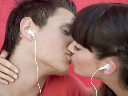 Young couple kissing, close-up - KMF00343