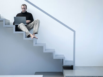 Young man using laptop - KM00494