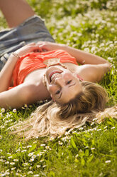 Young woman lying in meadow - KMF00228