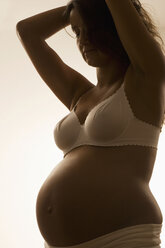 Pregnant woman, hands in hair, side view - LDF00285