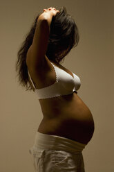 Pregnant woman, hands in hair, side view - LDF00282