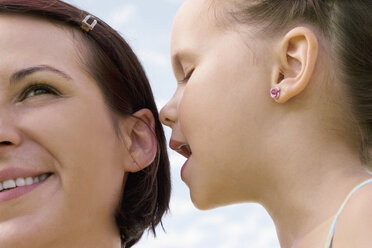 Daughter whispering in mother`s ear - LDF00336