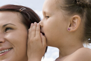 Daughter whispering in mother`s ear - LDF00335