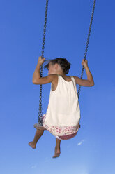 Girl (7-9) sitting on swing, rear view - LDF00300