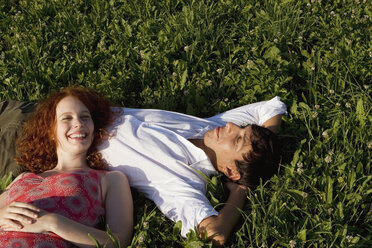 Woman lying with head on man`s belly, smiling - LDF00245