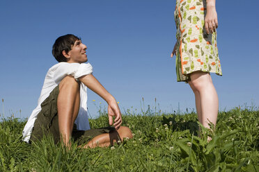 Young couple in meadow, man looking at woman, side view - LDF00226