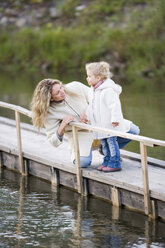 Mother with daughter on jetty - WESTF03031