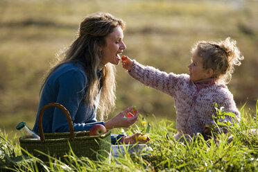 Daughter feeding mother, side view - WESTF03017