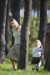 Mother playing with daughter in wood - WESTF03000