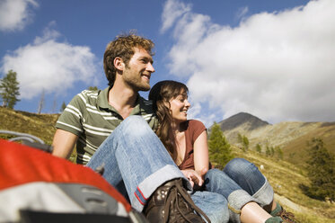 Young couple sitting in mountains - BABF00180