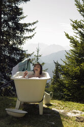 Young woman lying in bathtub - BABF00149