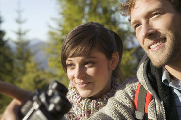 Young couple, man holding binocular - BABF00093