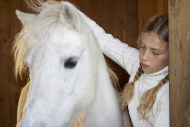 Girl stroking horse - WESTF02963