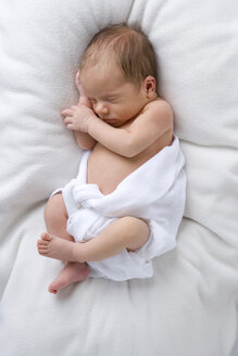 Baby in diaper sleeping, elevated view - SMOF00095