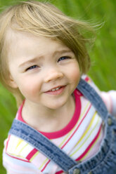 Girl (3-5) standing in meadow, elevated view - SMOF00088