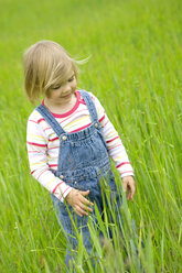 Girl (3-4) standing in meadow - SMOF00086